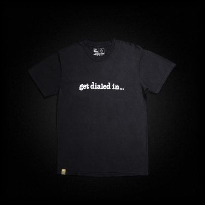 a black shirt is laid flat; printed on it is a white graphic that says "get dialed in..."