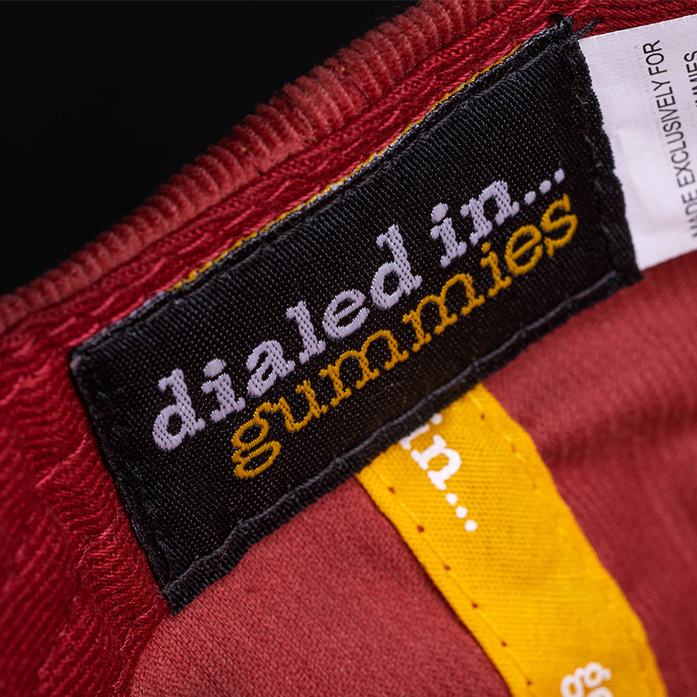inside view of a maroon hat with a dialed in... gummies sewn label